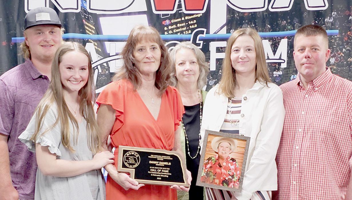 The Danny Daniels family was present for the induction of Danny Daniels into the 2023 Nebraska Scholastic Wrestling Coaches Association Hall of Fame for outstanding contributions in Nebraska Wrestling. Accepting the award were (Front Row Left to Right) Beth Frederickson, Teri Daniels, Jennifer Denny; (Back Row Left to Right) Jayden Maifeld, Brenda Lemay and Vance Denny.